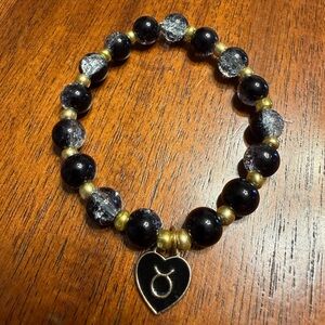 Elegant Black and Gold Beaded Bracelet with Taurus Zodiac charm